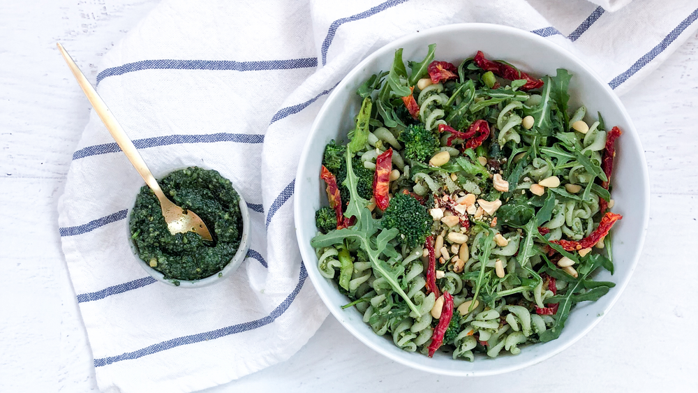 Two bowls of pesto pasta salad