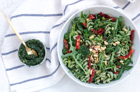Two bowls of pesto pasta salad